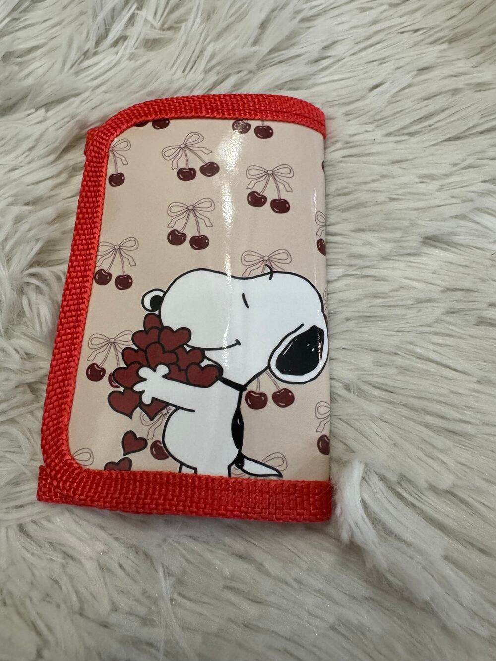 Snoopy zipper wallet holding a bouquet of hearts, surrounded by cherries & bows